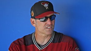 Arizona Diamondbacks manager Torey Lovullo talks with other coaches in the dugout prior to a spring training baseball game against the Chicago White Sox Thursday, March 9, 2017, in Glendale, Ariz. The White Sox defeated the Diamondbacks 4-2. (AP Photo/Ross D. Franklin)