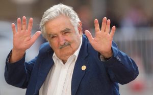 Uruguay's president Jose Mujica waves at the press upon his arrival at La Moneda presidential palace in Santiago, on March 10, 2014.
