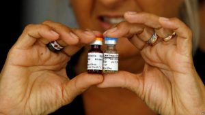 A Cuban health officer presents CimaVax EGF, medicine used in the treatment of advanced lung cancer, in Havana, Tuesday, June 24, 2008. Cuba began developing the medicine in 1992, and with its recent health and sanitary registration, Cuba could begin to commercialize it in Peru, Malaysia and China. CimaVax EGF medicine is a parallel treatment to chemotherapy, and is free for Cubans as part of their national health system. (AP Photo/Javier Galeano)