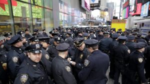 FILE- In this Dec. 31, 2015 file photo, police officers gather at the southern end of Times Square to receive their assignments for New Year's Eve in New York. Although New York Police Department officials say that while there are no specific or credible threats against the city, they are promising a bigger security detail than ever before at the New Year’s Eve celebration in Times Square. (AP Photo/Seth Wenig)