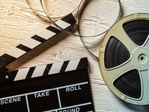 Film camera chalkboard and roll on wooden table