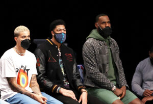 NEW YORK, NEW YORK - APRIL 10:  Kyle Kuzma #0,Anthony Davis #3 and LeBron James #23 of the Los Angeles Lakers look on from the bench in the first quarter against the Brooklyn Nets at Barclays Center on April 10, 2021 in the Brooklyn borough of New York City.NOTE TO USER: User expressly acknowledges and agrees that, by downloading and or using this photograph, User is consenting to the terms and conditions of the Getty Images License Agreement. (Photo by Elsa/Getty Images)