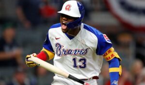 ATLANTA, GA - APRIL 11: Ronald Acuna Jr. #13 of the Atlanta Braves reacts after hitting a solo home run in the seventh inning against the Philadelphia Phillies at Truist Park on April 11, 2021 in Atlanta, Georgia.   Todd Kirkland/Getty Images/AFP (Photo by Todd Kirkland / GETTY IMAGES NORTH AMERICA / Getty Images via AFP)
